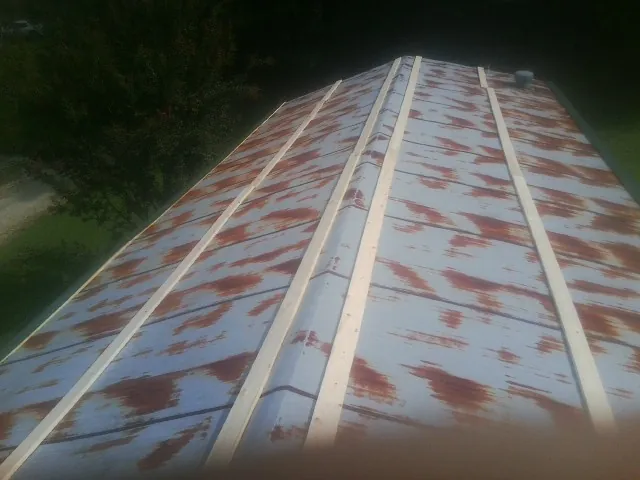 Rusted metal roof panels with new wood purlins before replacement — Storm Damage Roof Repair in Parlin by Roofing Brothers