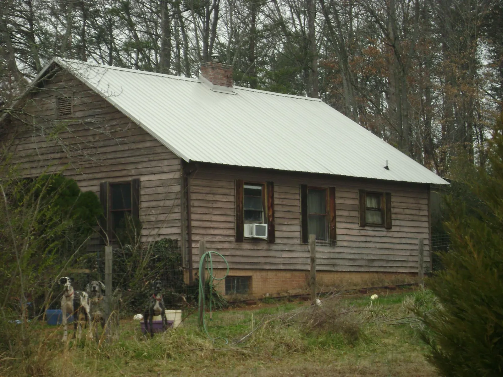 White metal roof on an old wood sided farmhouse, from a Metal Roof Installation job in Parlin
